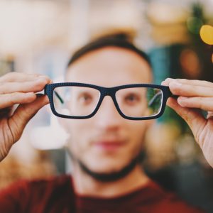 Keeping healthy in the workplace: Man looking through glasses