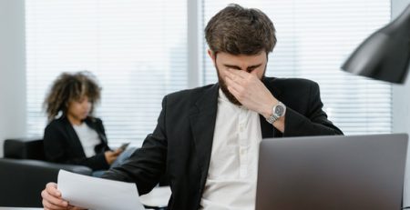 man-stressed-sitting-at-laptop